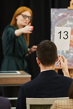 Real estate agents and clients shake hands